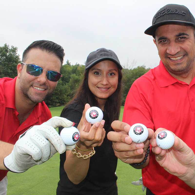 Foursome holding logo balls